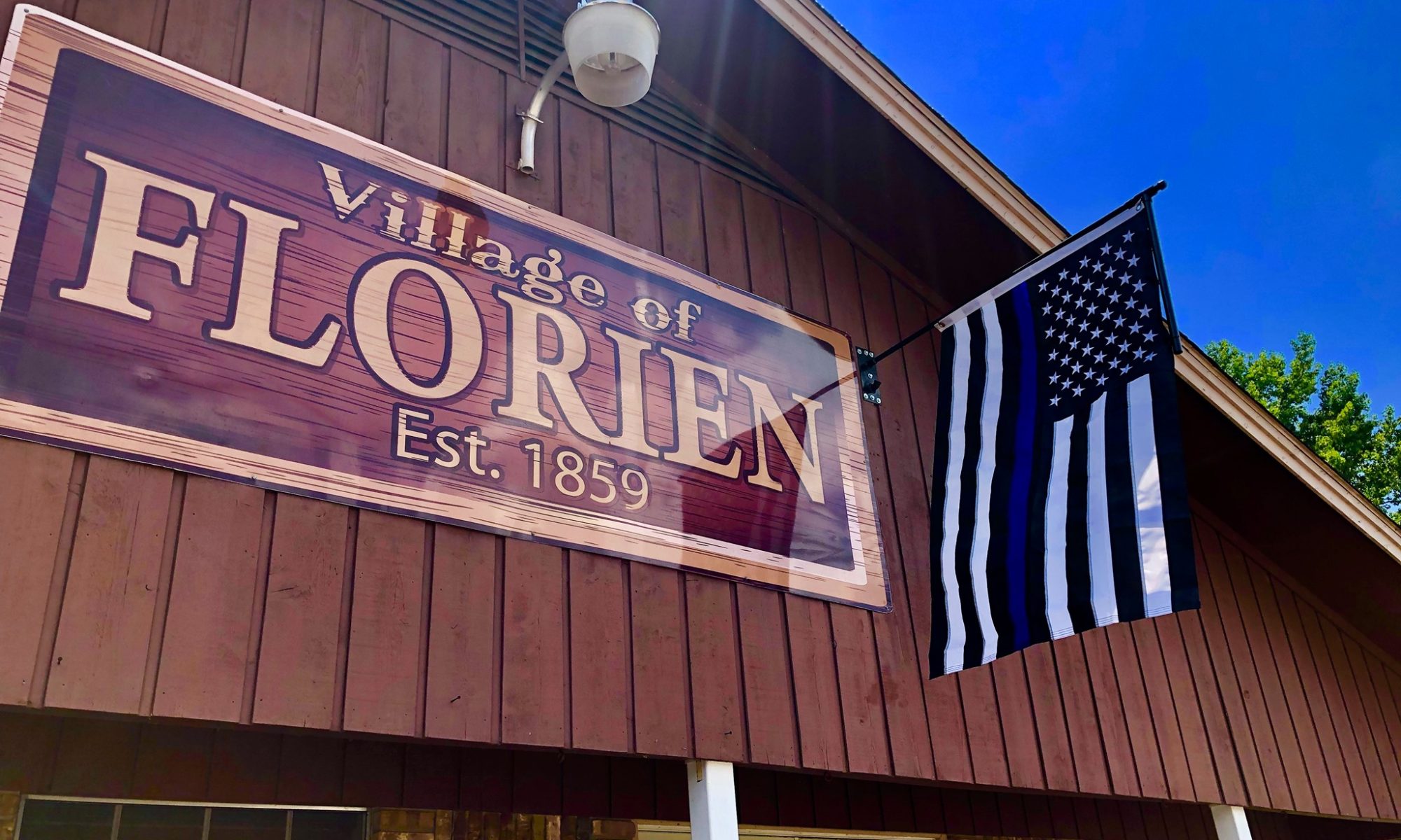 Village of Florien sign outside a local building